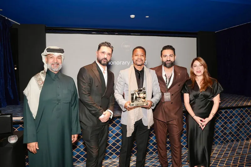 A winning team on stage with the Clapboard award in 2025